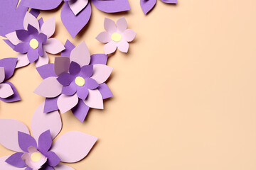 Colorful origami flowers on beige background