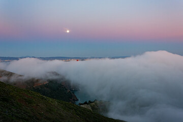Naklejka na ściany i meble Twilight aerial view of the Golden Gate Bridge with fog
