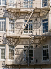 Sunny view of a building with many window and stairs