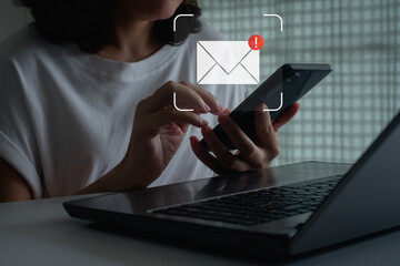 Email inbox serves alert notifications for internet security, guarding against spam, viruses, compromised data. Cautionary measures ensure protection from junk and trash mail. Woman using smartphone.