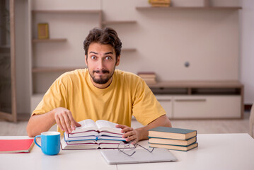 Young male student preparing for exams at home