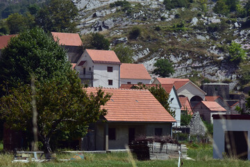 Fototapeta na wymiar Small stone village in Montenegro. Old village on countryside of Njegusi, Montenegro. Rural scenery on a sunny day.