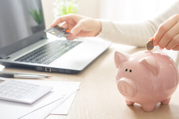Obraz na płótnie Canvas Piggy bank and golden coin. Savings and finance concept 