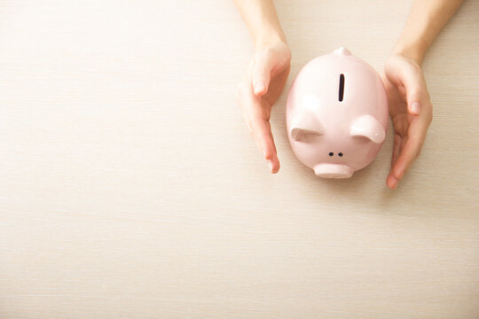Piggy bank and golden coin. Savings and finance concept	