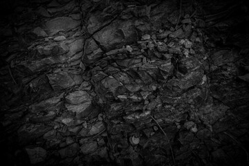 Black rock. Abstract dark weathered stone background.