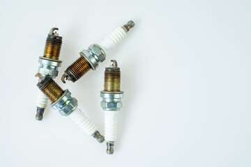 Group of old very damaged car spark plugs, close-up of old used car spark plugs that don't work...