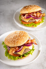 Delicious hamburger with meat, cheese, bacon and salad.