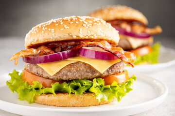 Delicious hamburger with meat, cheese, bacon and salad.