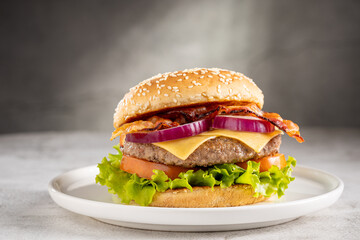 Delicious hamburger with meat, cheese, bacon and salad.