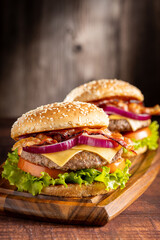 Delicious hamburger with meat, cheese, bacon and salad.