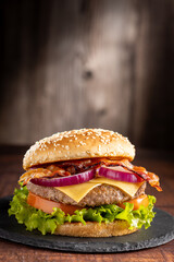 Delicious hamburger with meat, cheese, bacon and salad.
