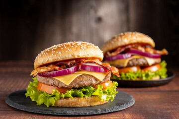 Delicious hamburger with meat, cheese, bacon and salad.