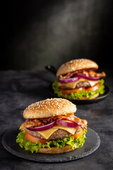 Delicious hamburger with meat, cheese, bacon and salad.