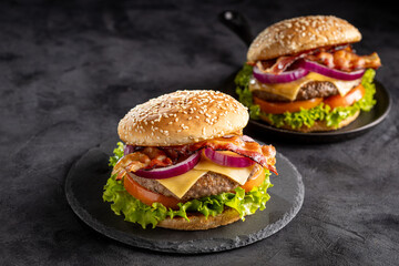 Delicious hamburger with meat, cheese, bacon and salad.