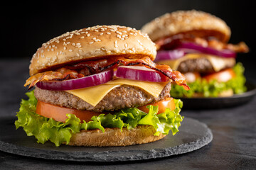 Delicious hamburger with meat, cheese, bacon and salad.