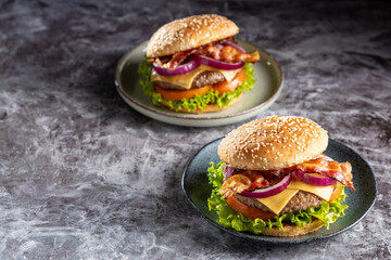 Delicious hamburger with meat, cheese, bacon and salad.