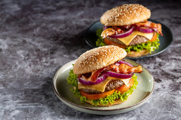 Delicious hamburger with meat, cheese, bacon and salad.