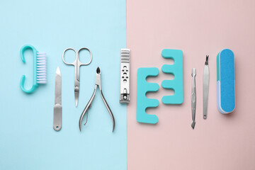 Set of pedicure tools on color background, flat lay