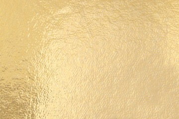 Edible gold leaf sheet as background, closeup