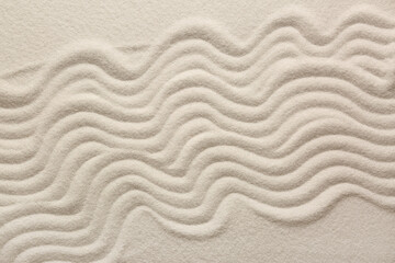 White sand with pattern as background, top view. Zen concept