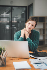 Young businesswoman in the office, Young woman suffering from neck pain in office.