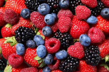 Many different fresh ripe berries as background, top view