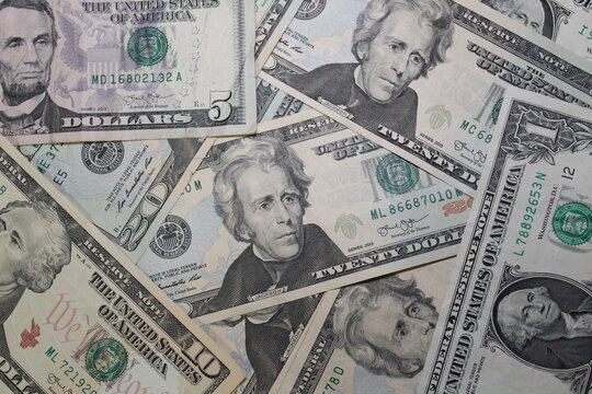 US dollar bills in different denominations scattered around.