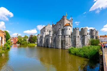 The medieval Gravensteen castle along the Leie River on a sunny summer day in the East Flanders city of Ghent, Belgium.