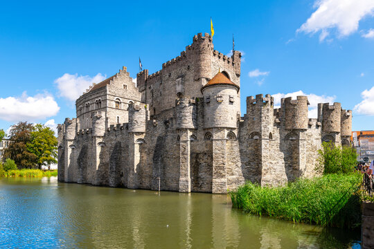 The medieval Gravensteen castle along the Leie River on a sunny summer day in the East Flanders city of Ghent, Belgium.