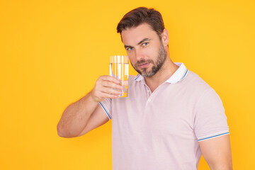 Man drinking water isolated on studio background. Portrait of man with glass of fresh water. Thirsty man. Refreshing. Water balance. Portrait of man drinking pure water.