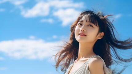 Fototapeta premium 青空の中にいる少女・アジア人女性（夏・空・清純・純粋） 