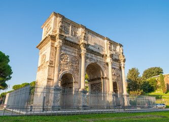 Fototapeta na wymiar Arch of Constantine at sunrise in Rome. Text translation 