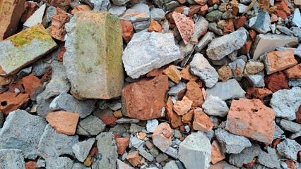 Pile of broken red bricks and fragments of concrete from destroyed building