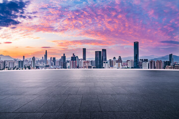 City square and skyline with modern buildings in Shenzhen at sunrise, Guangdong Province, China.