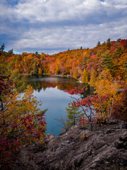 Fall foliage, autumn colours around Pink Lake, Gatineau Park, Quebec, Canada. Photo taken in October 2022. 