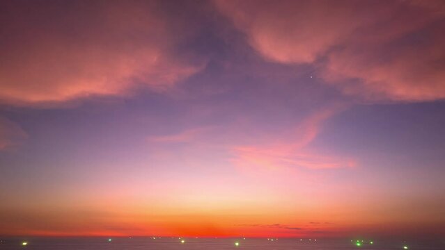 Aerial hyperlapse view of pink sky above the island .The hyperlapse view captures the beauty of the pink sky as it slowly changes from a light pink to a deep, vibrant hue..sweet sky background.