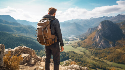 Young man with backpack hiking mountains. Hiker having trekking day out on a sunny day. - obrazy, fototapety, plakaty