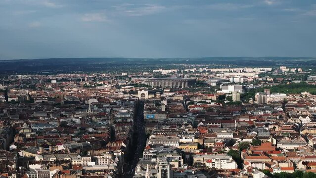 Aerial panoramic view of urban borough in metropolis at golden hour. Modern sports stadium, Puskas Arena in background. Budapest, Hungary