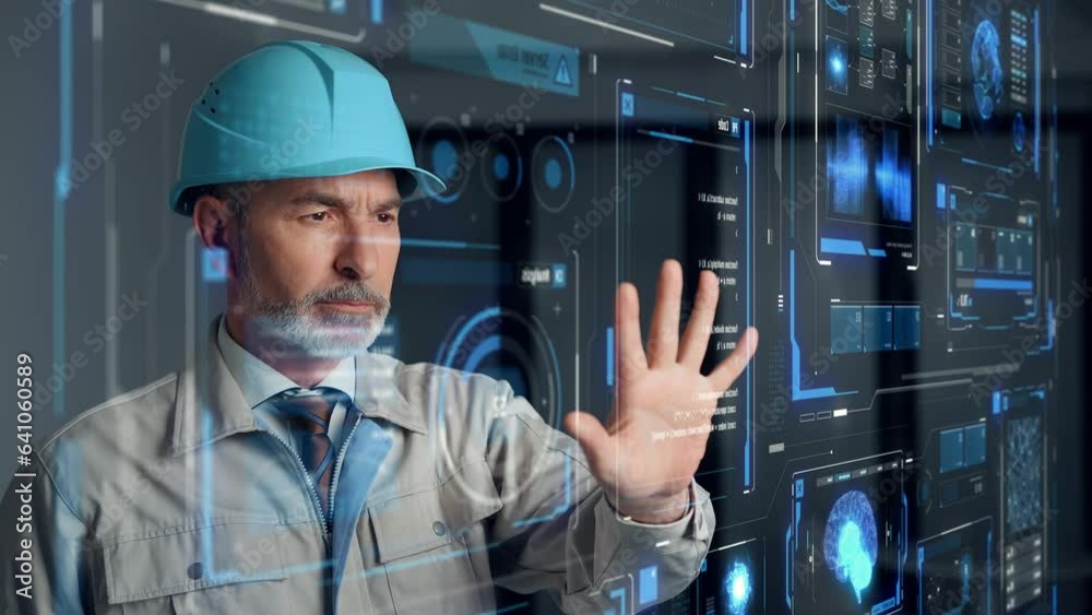 Aufkleber Middle aged engineer watching futuristic graphical user interface.