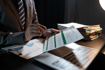 Asian businessman working on paperwork on desk Gather documents from meeting minutes. Documents financial Reports Accountant working in the office. Accounting concept. Business finance.