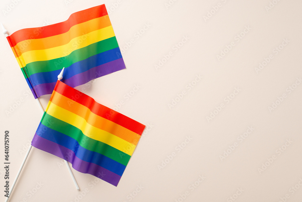 Sticker Flat lay photo of LGBT flags from festival including lesbians gays bisexuals and transgender people on beige background with empty space for text