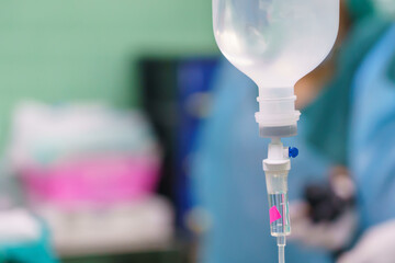 Normal saline solution or sodium chloride with infusion bottle drip for patient in hospital,...