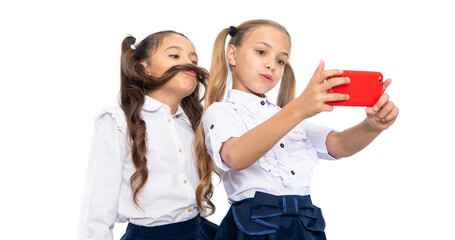 school children making selfie in classroom. back to school. girls children having selfie time. school friends blogging and taking selfie with phone. school vacations