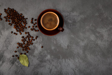 A cup of coffee and coffee beans on the table. .