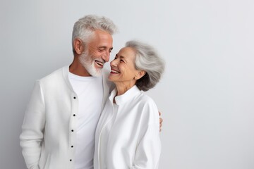 Beautiful gorgeous 50s mid age elderly senior model couple with grey hair laughing and smiling. Mature old man and woman close up portrait. Healthy face skin care beauty, skincare cosmetics, dental.