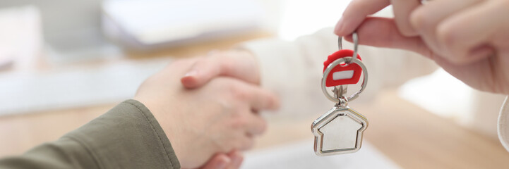 The handshake real estate agent with a client, key transfer