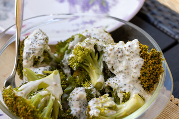 Healthy diet. Steamed broccoli topped with yogurt sauce