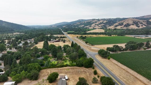Aerial California Boonville city vineyard farms traffic 2. Mendocino county, California. Grape, wine farm regions along Navarro River. Mountains, hills, valley and farming. Redwood and pine forests.