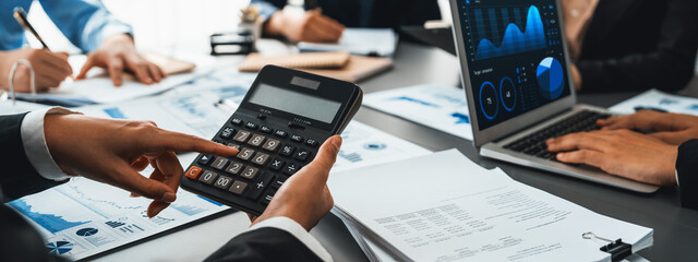 Auditor and accountant team working in office, analyze financial data and accounting record with calculator. Accounting company provide finance and taxation planning for profitable cash flow. Insight