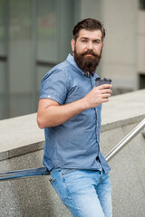 photo of bearded mature man at coffee break. mature man at coffee break outdoor.